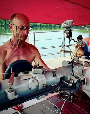Sailor Henning working on Deck with an sewing machine.